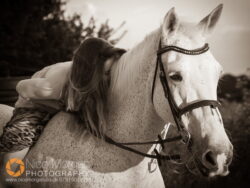 equestrian-photographer-girl-with-rides-grey-horse-dress-bandw