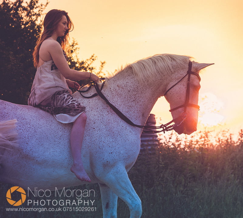 equestrian-photographer-girl-with-rides-grey-horse-dress-sunset