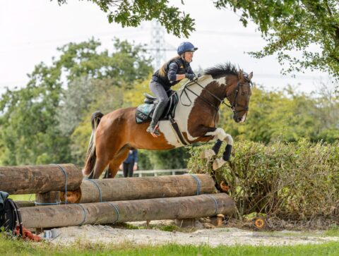 Laura Hall jumping on a coloured pony
