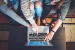 Young people pointing at a laptop screen