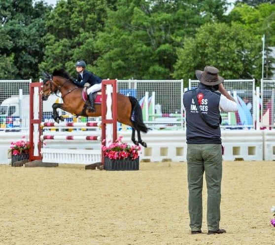 Nico Morgan engaged in event photography in a showjumping ring