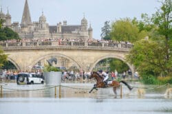 Bubby Upton crosses the lake at Burghley with the Lion Bridge and Burghley House in the background